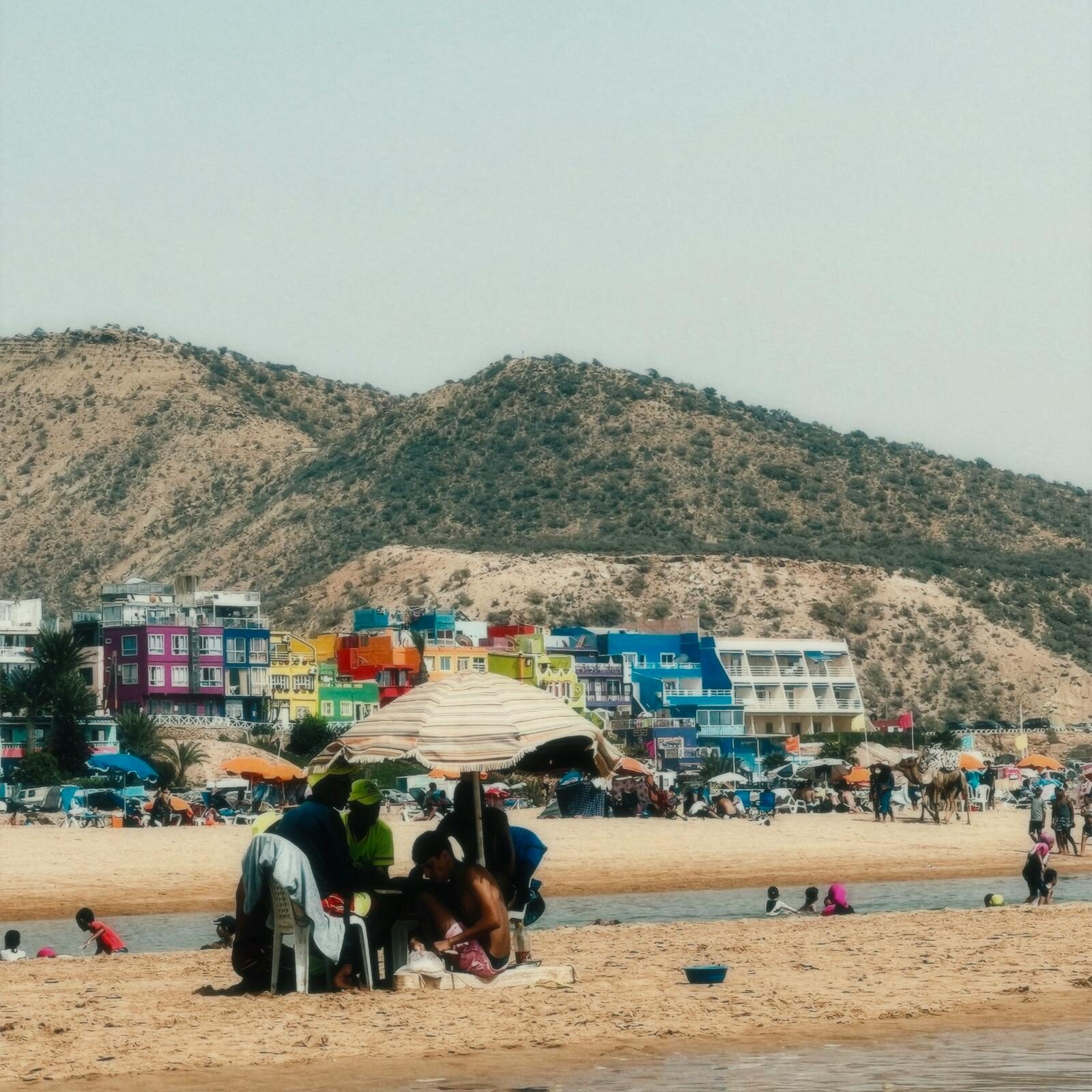 Moroccan family on the beach near Taghazout, dressed modestly