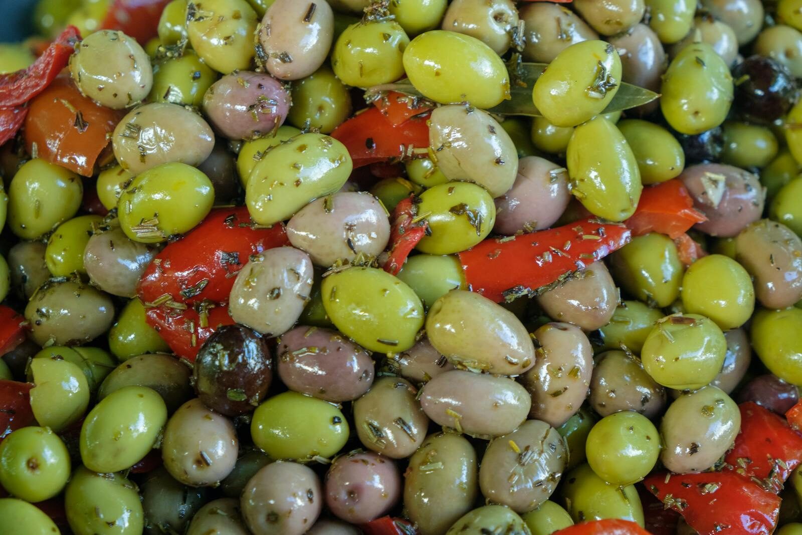 Fresh ingredients: olives, herbs, salads on display