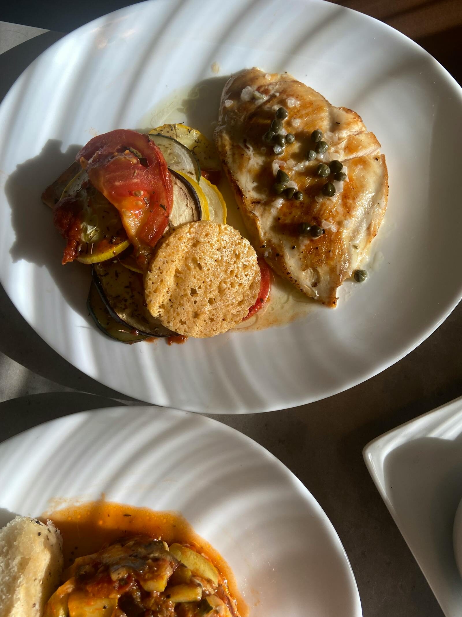 Grilled chicken plated Mediterranean-style