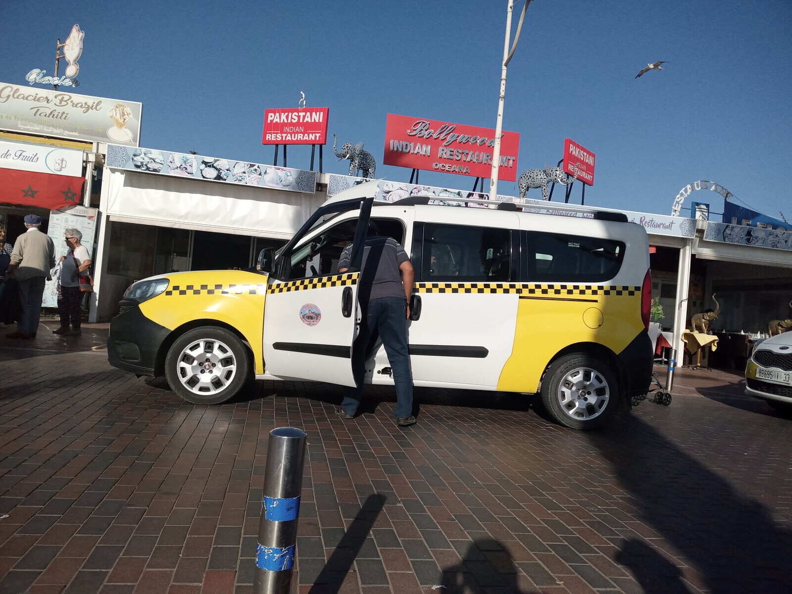 A Moroccan grand taxi — a beige Mercedes sedan used for inter-city travel between Marrakech and Agadir