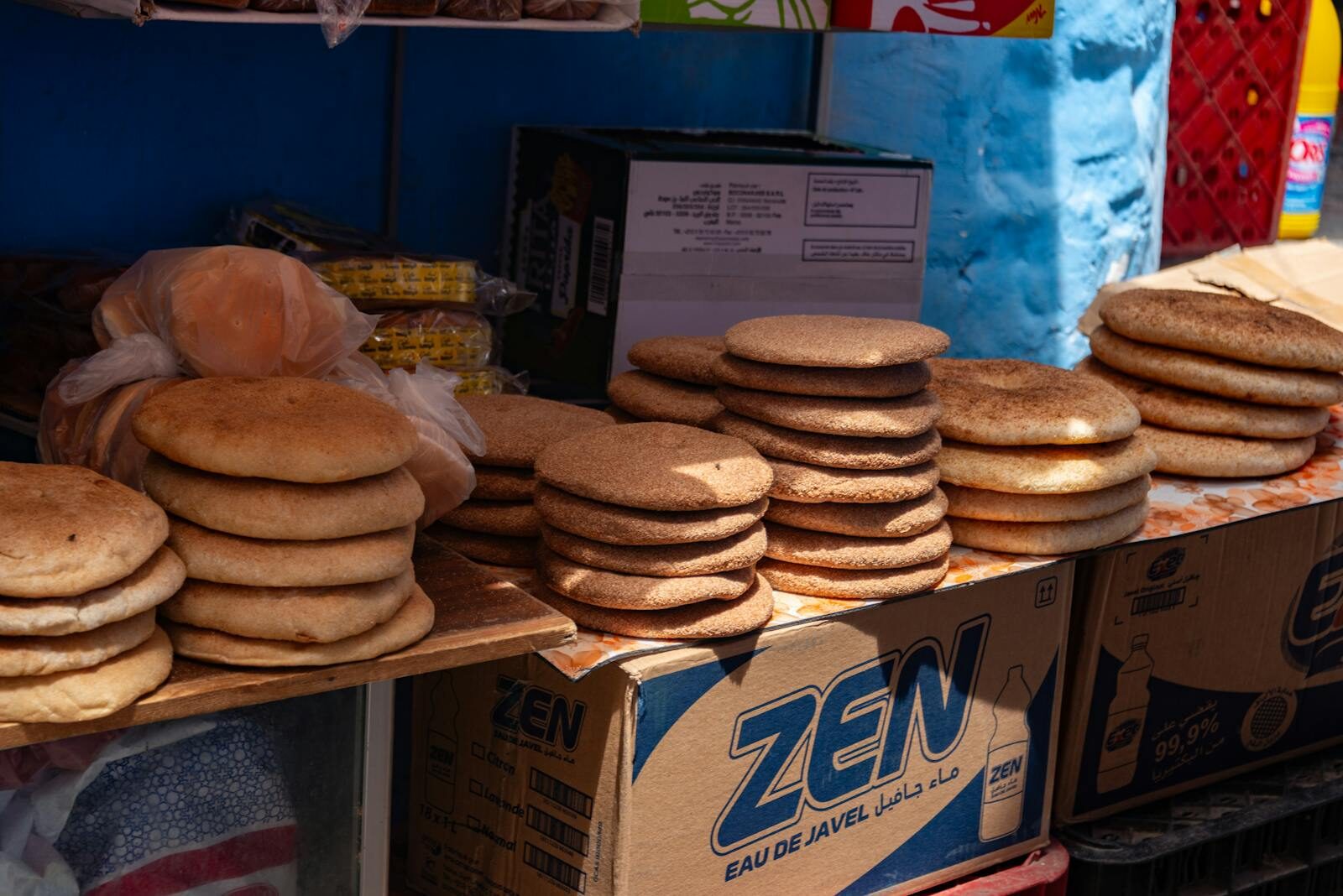 Moroccan bread khobz and msemmen torn by hand on a table at Restaurant Rafiq Agadir