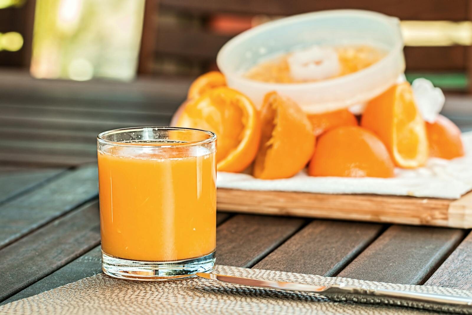 Glass of fresh-squeezed orange juice on a wooden table, the brunch standard at TamTam Agadir