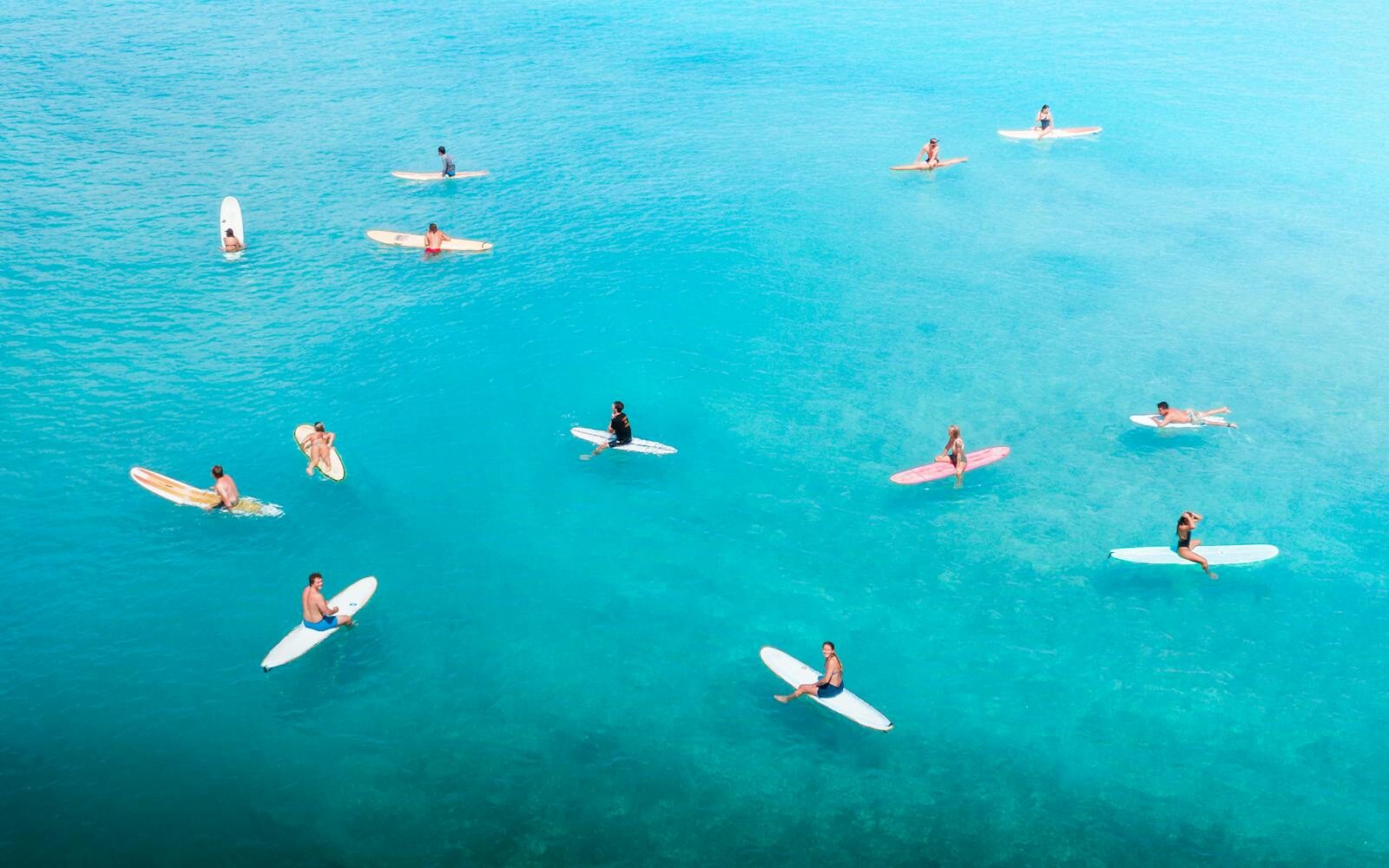 Aerial view of a crowded weekend lineup with many surfers and boards in the water