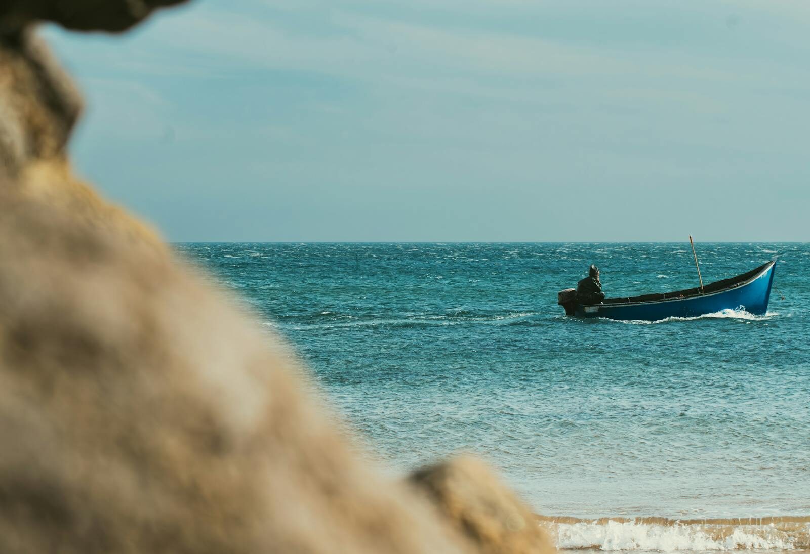 Blue Moroccan fishing boats pulled up on the Taghazout beach