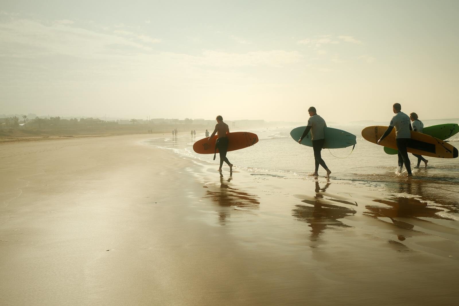 Silhouetted surfers in the lineup at sunset on the Moroccan Atlantic coast