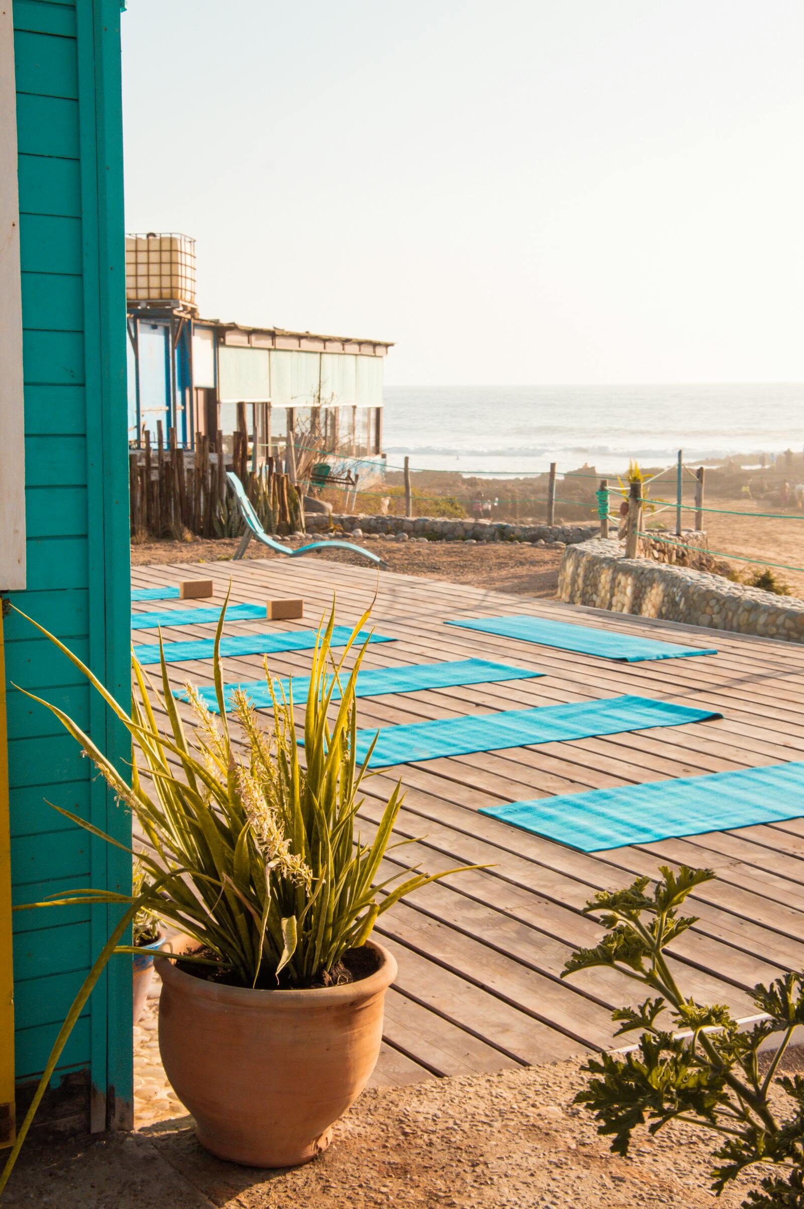 Wooden yoga deck overlooking the ocean at sunset