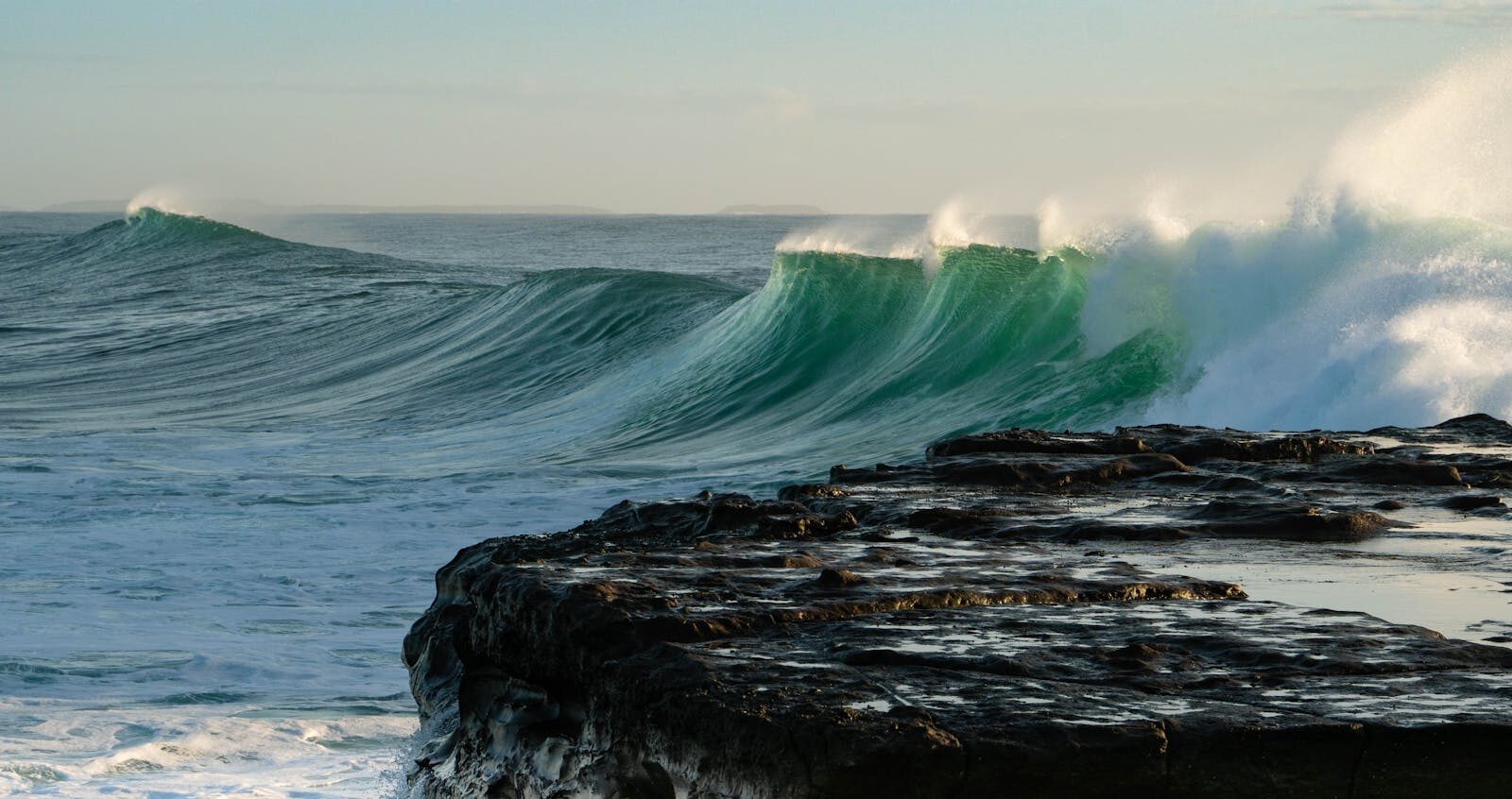Thick powerful right-hand point break breaking over rocks at Killer Point Taghazout, Morocco